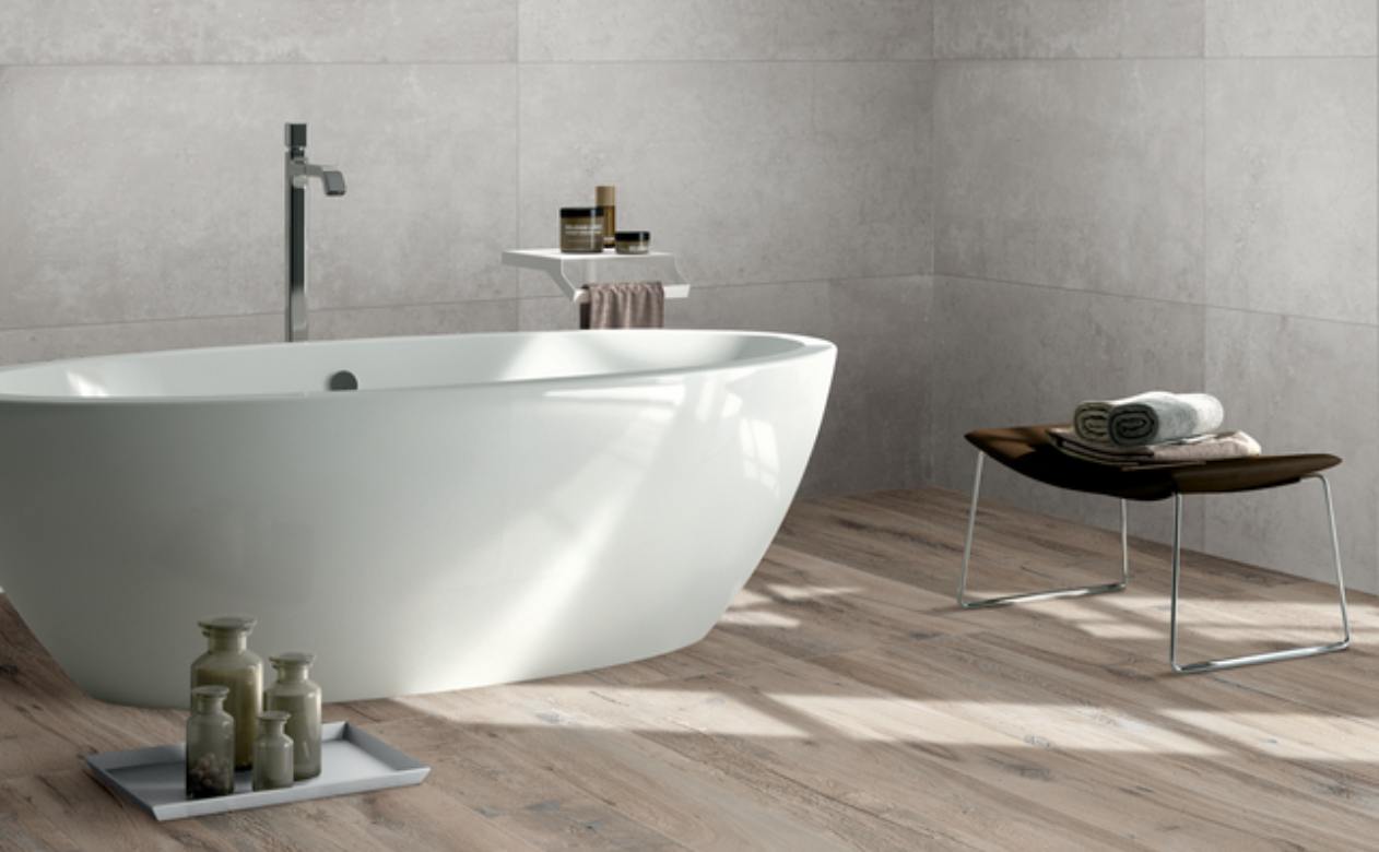 wood look tile flooring in bathroom with bathtub